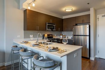 Kitchen with stainless steel appliances and a large island
